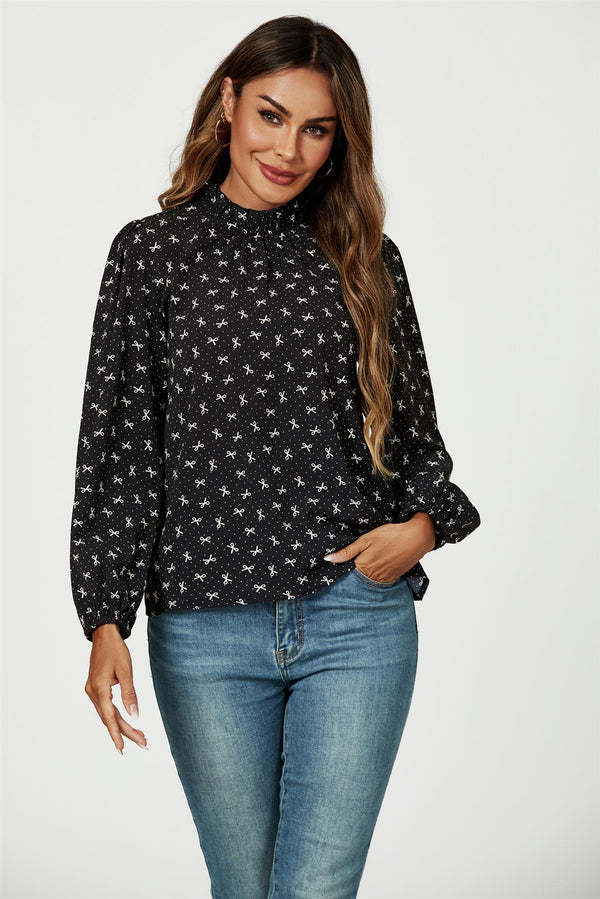 Top met hoge hals en strikprint en ruches in zwart